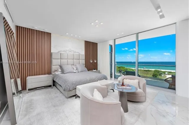 a bedroom with furniture and a large window