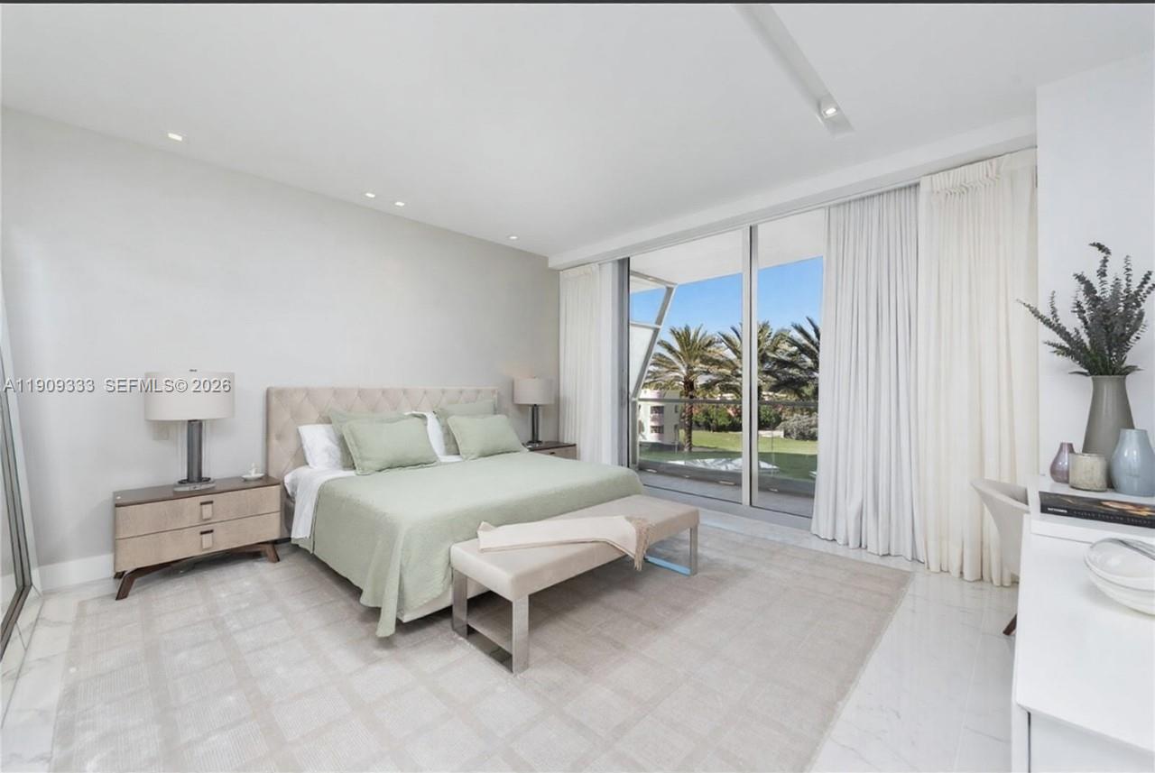 9349 Collins Avenue, Unit 304 Surfside, FL 33154 - Photo 29 of 40 a spacious bedroom with a bed and a couch