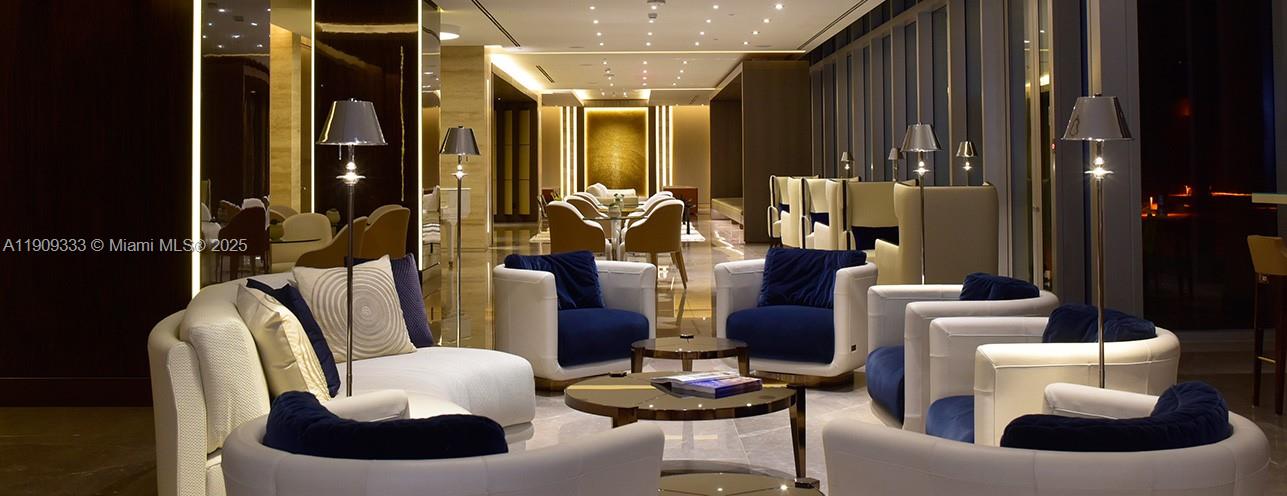 9349 Collins Avenue, Unit 304 Surfside, FL 33154 - Photo 38 of 40 a living room with furniture and lamp