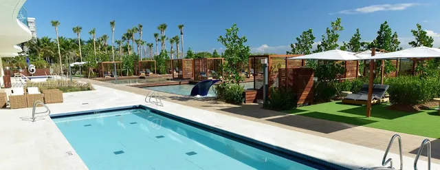 a view of a backyard with plants and outdoor seating