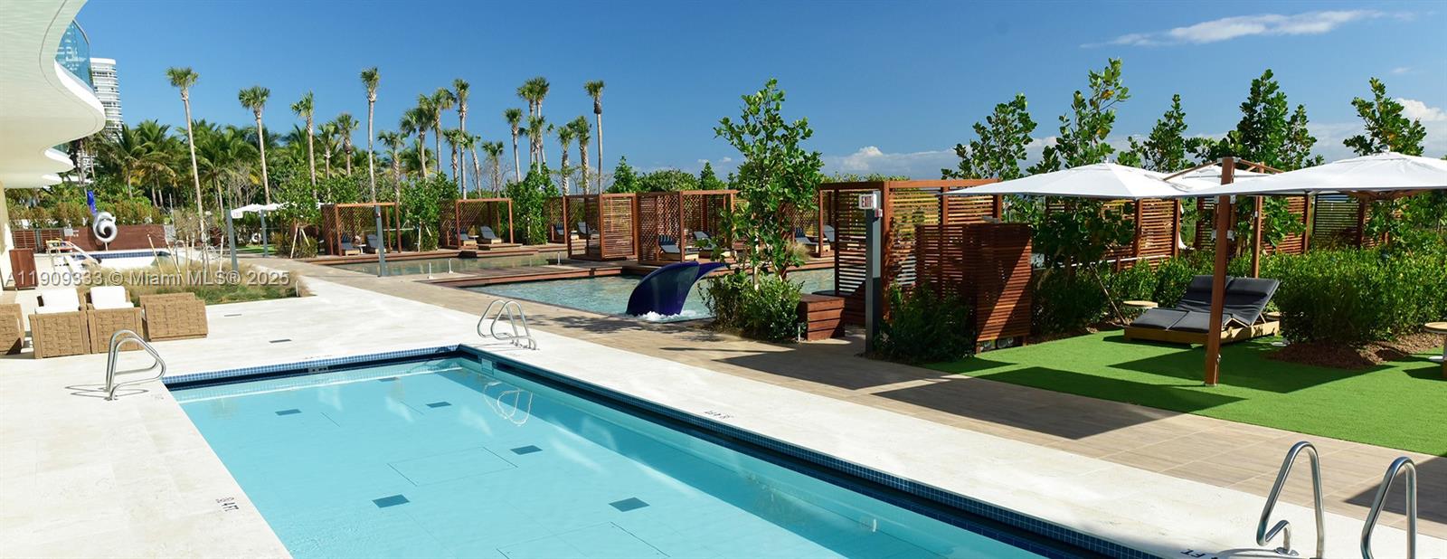 9349 Collins Avenue, Unit 304 Surfside, FL 33154 - Photo 39 of 40 a view of a backyard with plants and outdoor seating