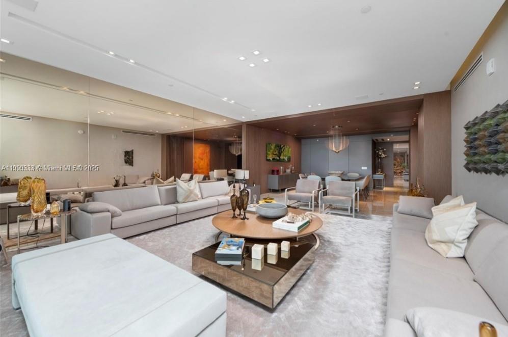 9349 Collins Avenue, Unit 304 Surfside, FL 33154 - Photo 5 of 40 a living room with furniture and a wooden floor