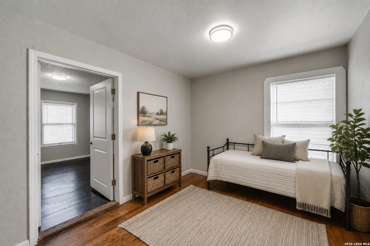 2307 Basse Road San Antonio, TX 78213 - Photo 10 of 17 a bedroom with a bed and a potted plant