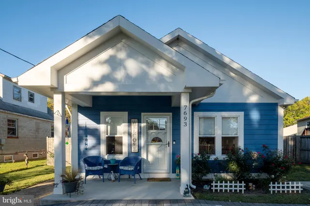 a front view of a house with outdoor seating and floor