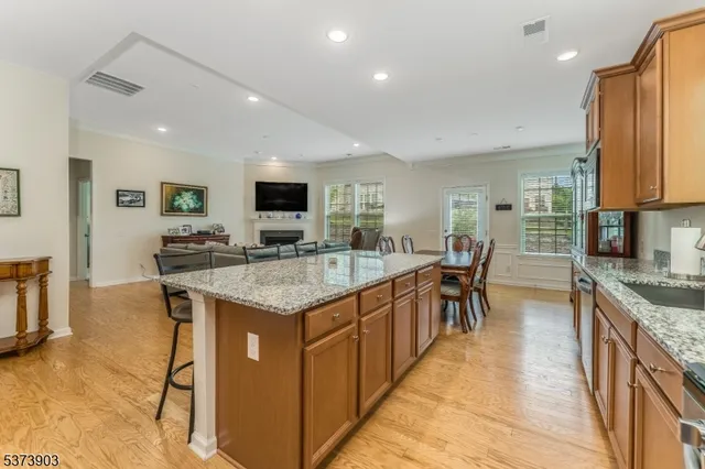 a kitchen with granite countertop sink stove and cabinets