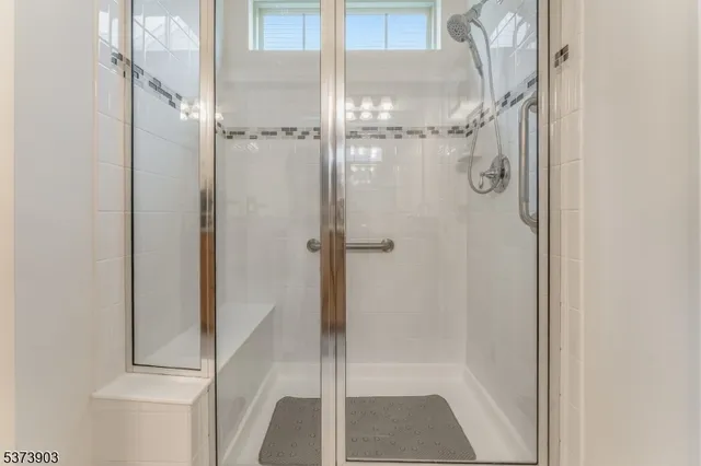 a bathroom with a glass shower door