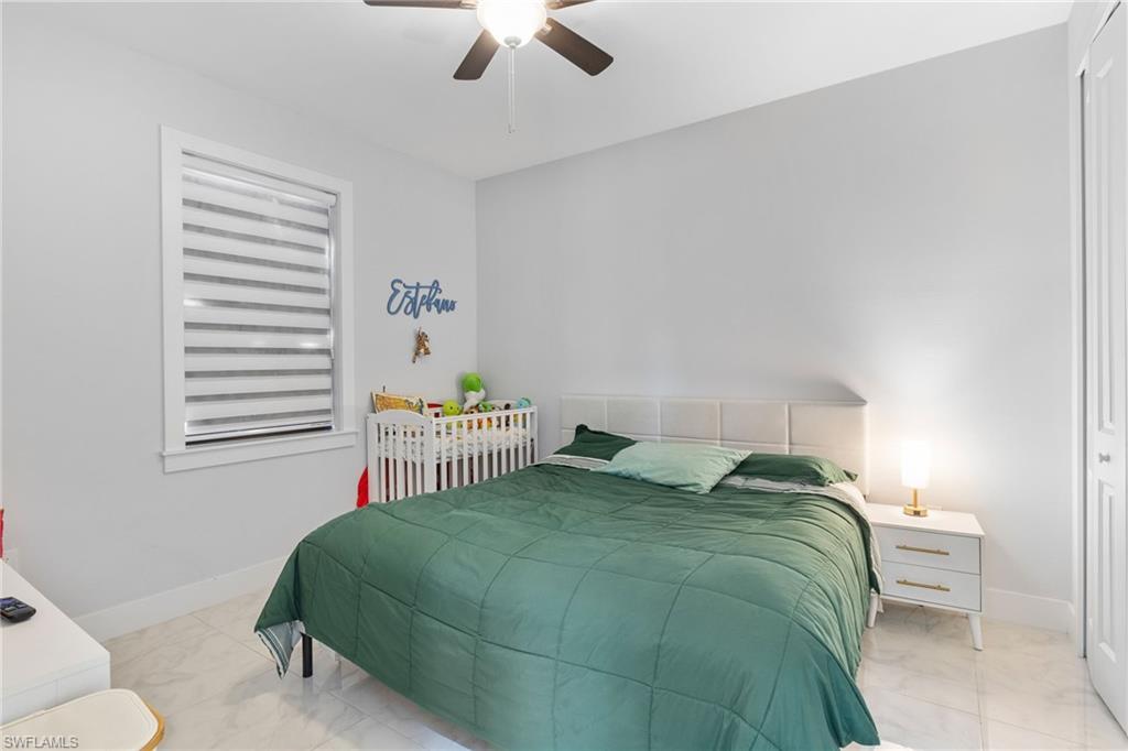 2406 37th Avenue Northeast Naples, FL 34120 - Photo 17 of 29 Bedroom with a closet and a ceiling fan