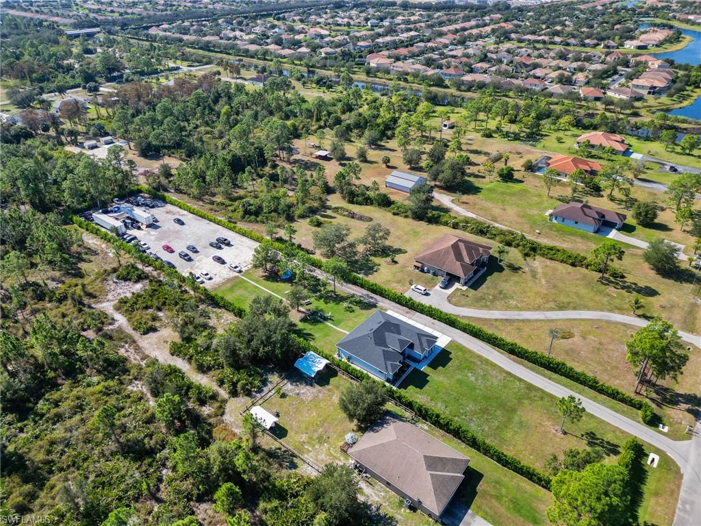 2406 37th Avenue Northeast Naples, FL 34120 - Photo 27 of 29 Aerial view of property and surrounding area with nearby suburban area