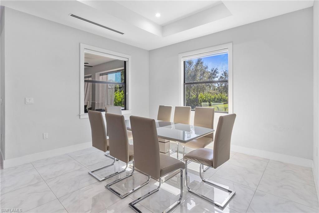 2406 37th Avenue Northeast Naples, FL 34120 - Photo 4 of 29 Dining area with a raised ceiling and recessed lighting