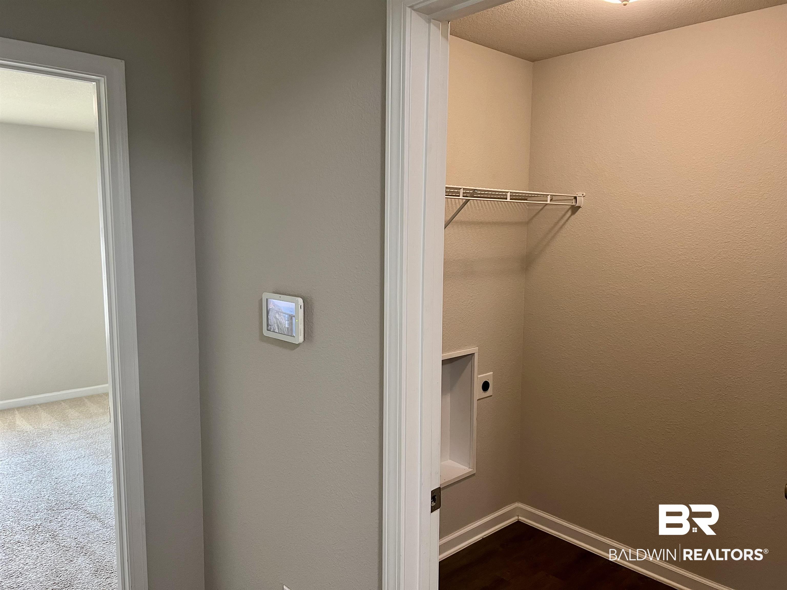 1612 Abbey Loop Foley, AL 36535 - Photo 23 of 30 Laundry room featuring carpet flooring, a textured ceiling, and electric dryer hookup