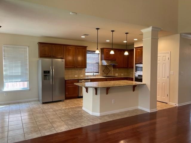 706 South Frontier Lane Cedar Park, TX 78613 - Photo 11 of 32 a kitchen with stainless steel appliances granite countertop a refrigerator a sink and a stove