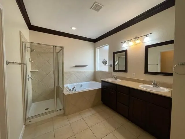 a bathroom with a double vanity sink mirror and shower