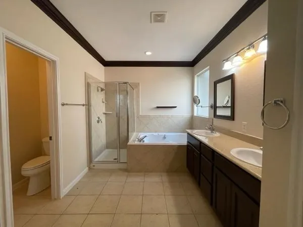 a bathroom with a granite countertop sink mirror bathtub and toilet