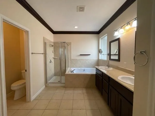 a bathroom with a granite countertop sink mirror bathtub and toilet