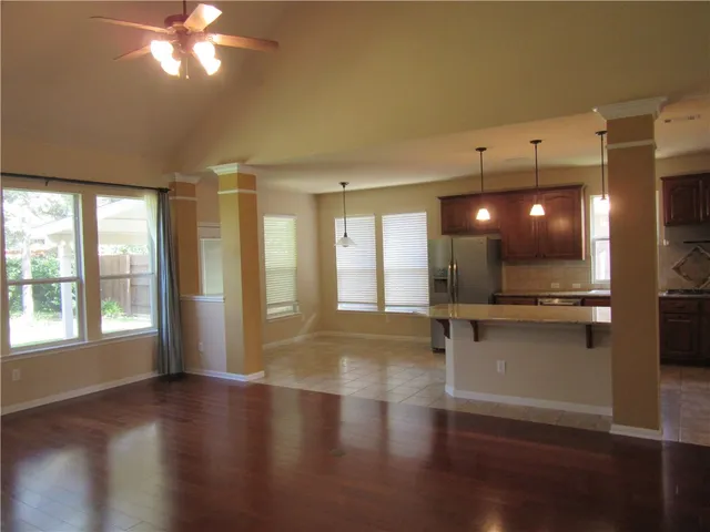 a view of a livingroom with furniture wooden floor and windows
