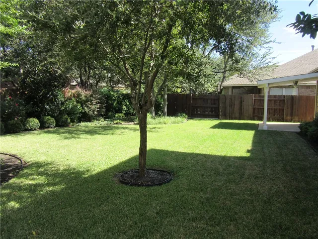 a swimming pool with lots of tress in front of it