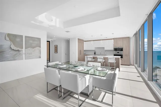 a living room with furniture and view of kitchen