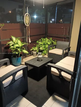 a dining room with furniture and potted plants