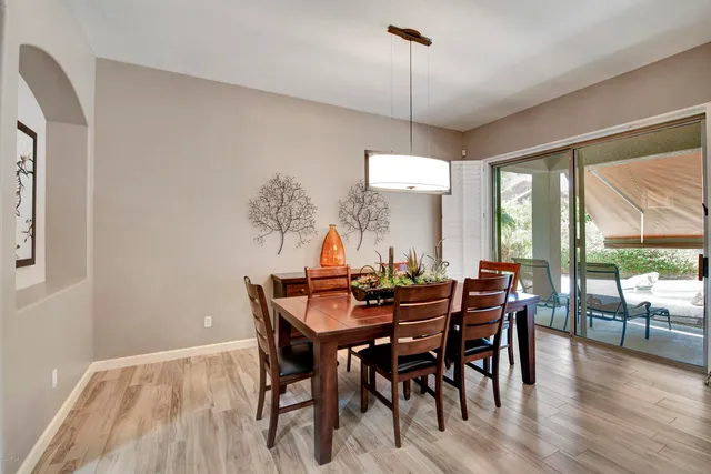a living room with furniture a flat screen tv and kitchen view