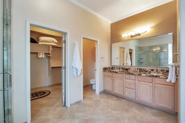 a large bathroom with a double vanity sink mirror and shower