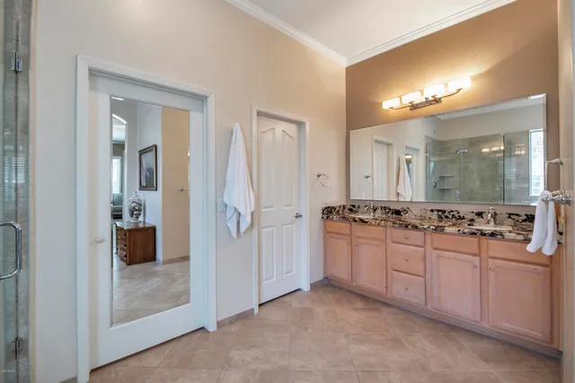 a bedroom with a bed and a chandelier