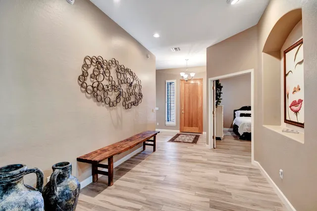 a living room with furniture and a view of kitchen