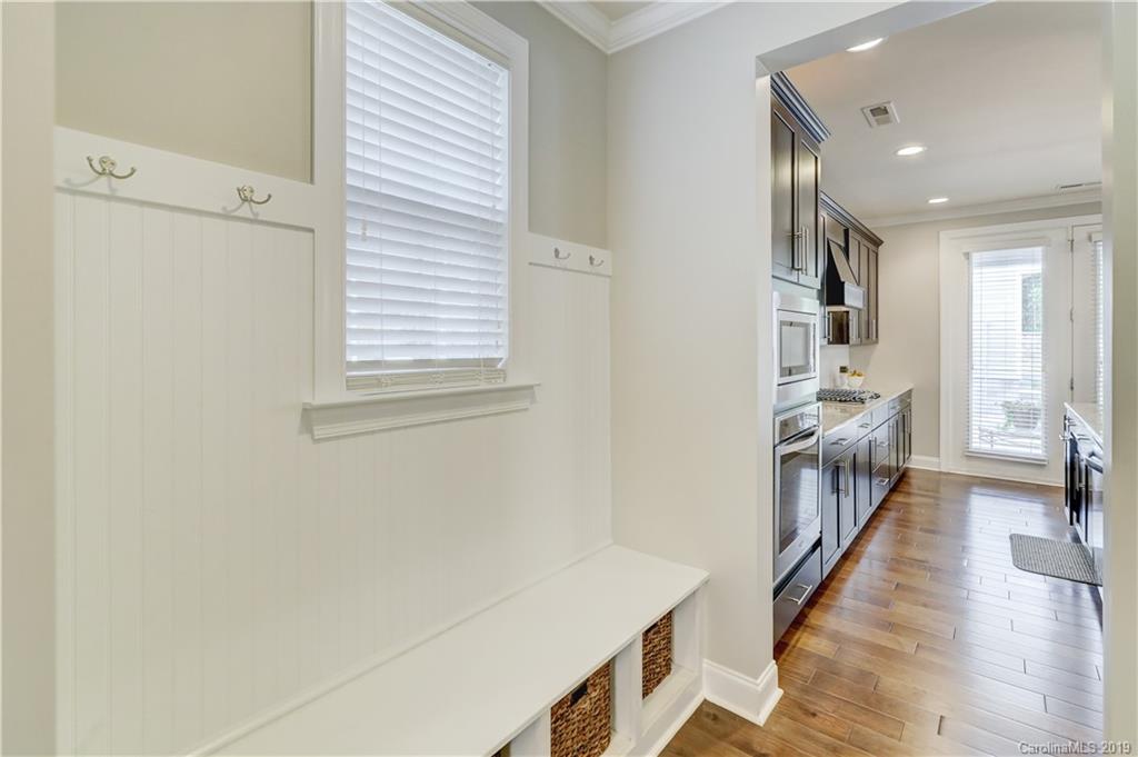 108 Helton Lane Fort Mill, SC 29708 - Photo 11 of 48 a hallway with white cabinets and wooden floor
