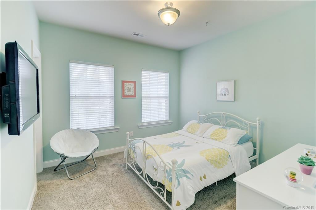 108 Helton Lane Fort Mill, SC 29708 - Photo 32 of 48 a bedroom with a bed and a chair