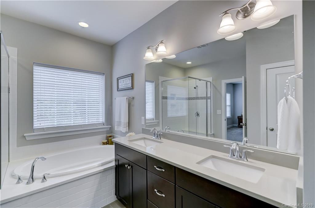 108 Helton Lane Fort Mill, SC 29708 - Photo 37 of 48 a bathroom with a tub a sink double vanity and a mirror