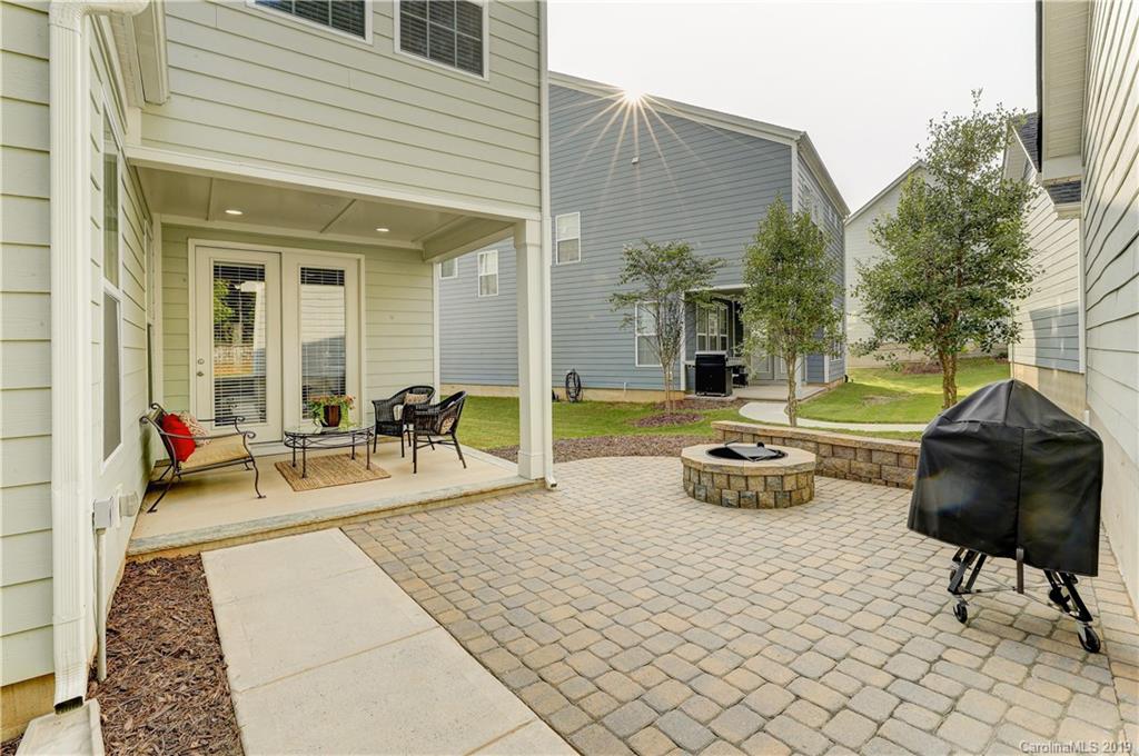 108 Helton Lane Fort Mill, SC 29708 - Photo 43 of 48 a view of a patio with dining table and chairs with couches potted plants and large tree