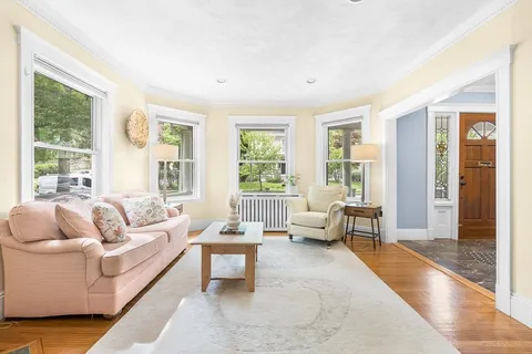 a living room with furniture and large windows