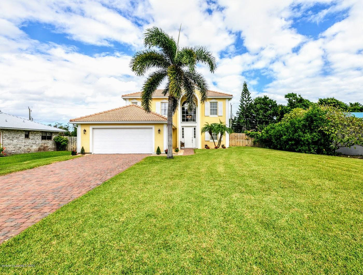 230 Richards Road Melbourne Beach, FL 32951 - Photo 1 of 42 a front view of a house with a garden and yard