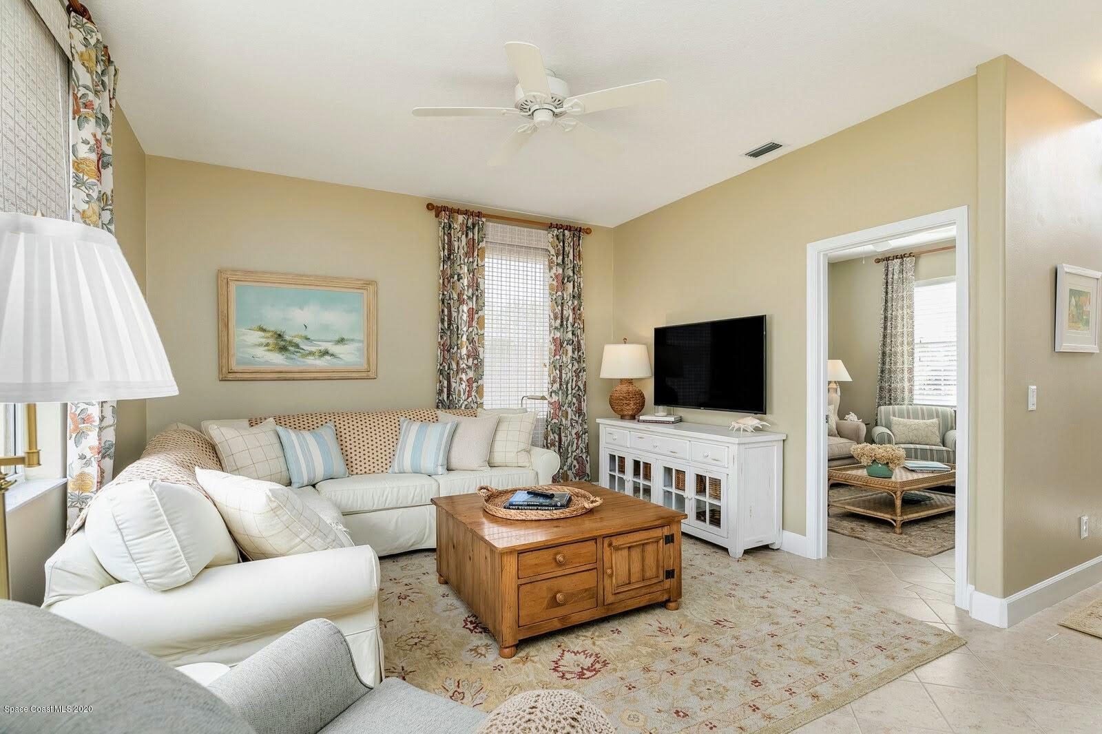 230 Richards Road Melbourne Beach, FL 32951 - Photo 11 of 42 a living room with furniture and a flat screen tv