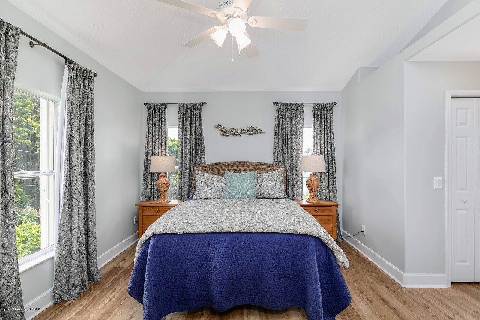 230 Richards Road Melbourne Beach, FL 32951 - Photo 15 of 42 a bed sitting in a bedroom next to a window