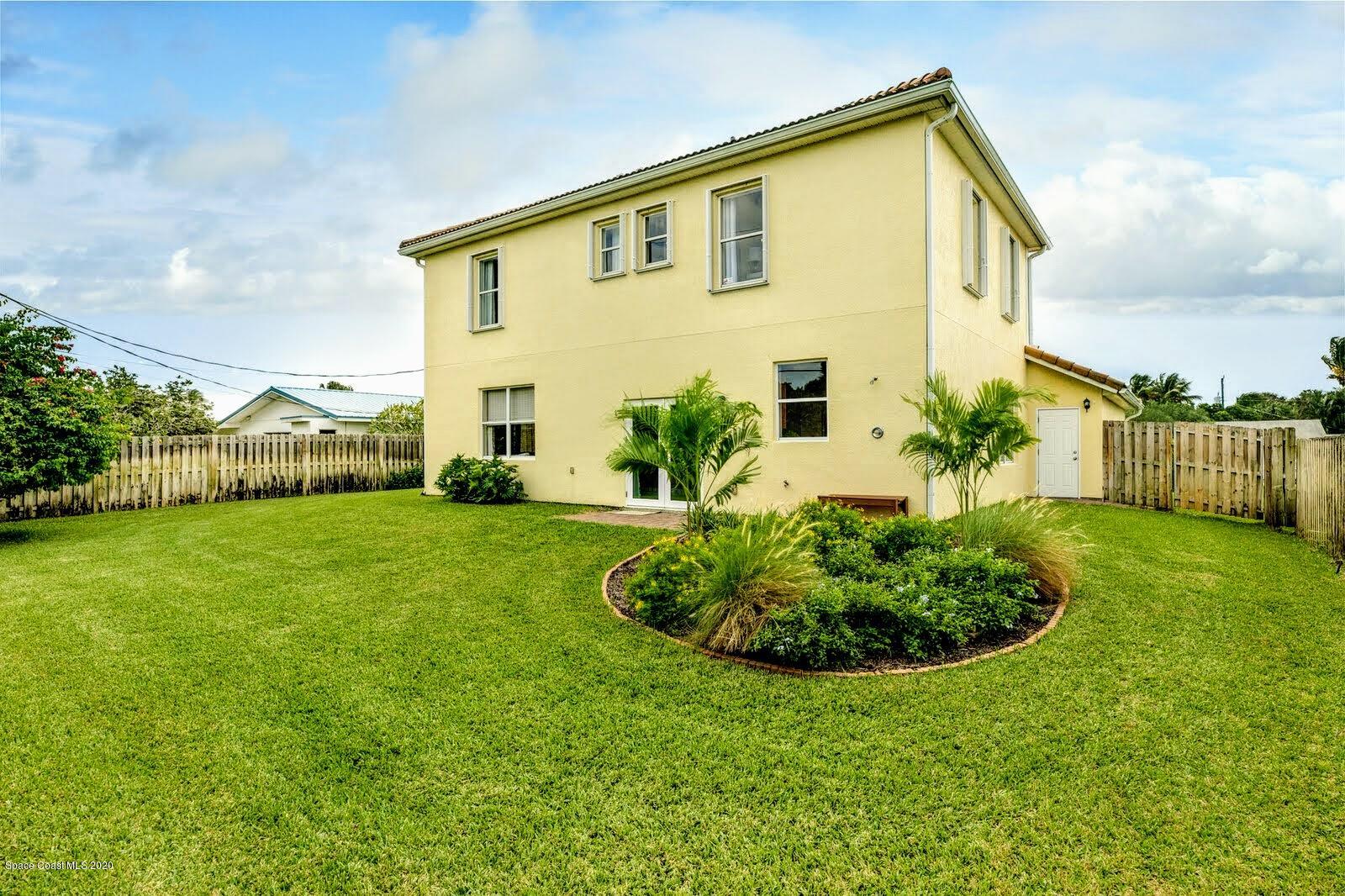 230 Richards Road Melbourne Beach, FL 32951 - Photo 18 of 42 a front view of a house with a yard
