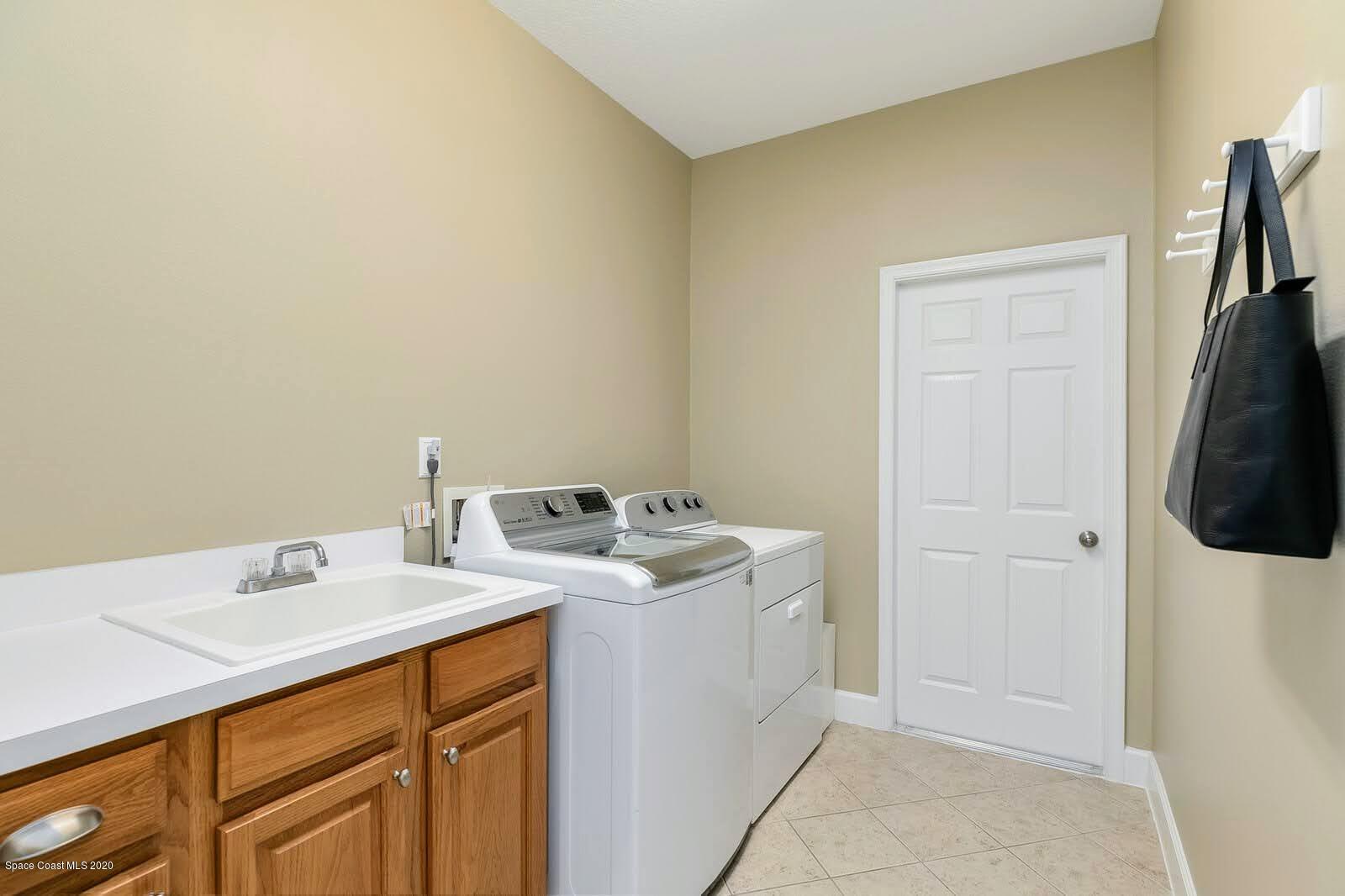230 Richards Road Melbourne Beach, FL 32951 - Photo 19 of 42 a utility room with dryer and washer