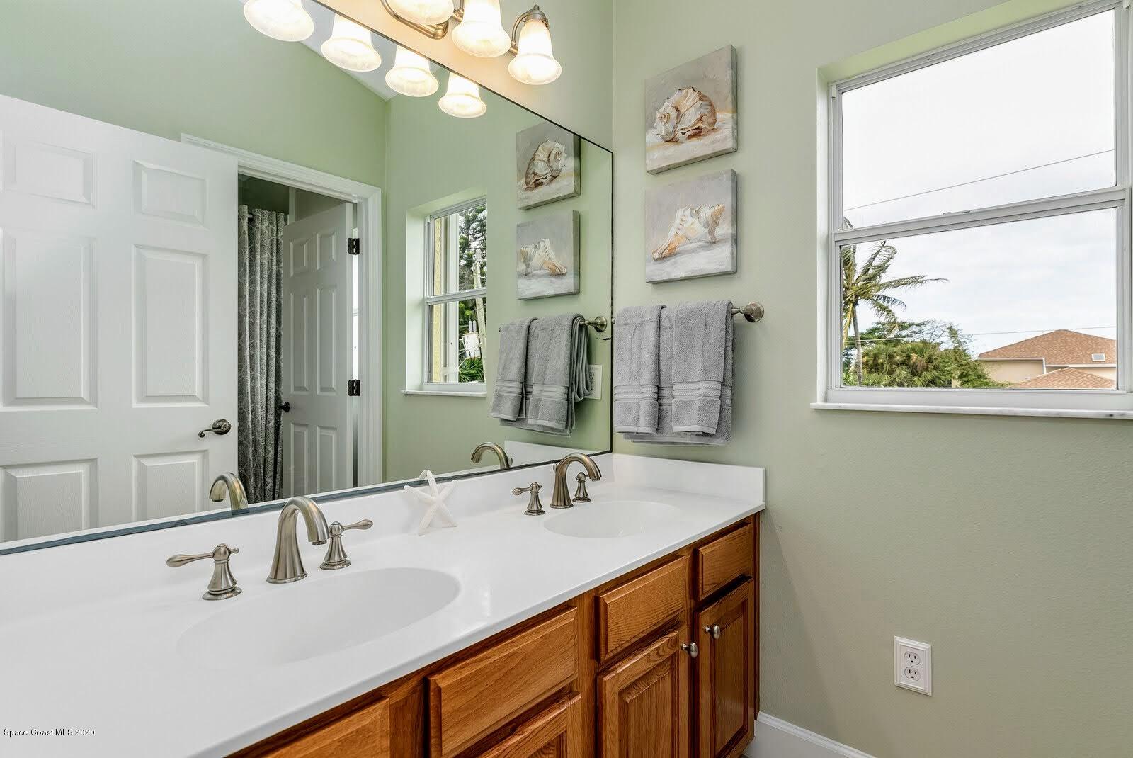 230 Richards Road Melbourne Beach, FL 32951 - Photo 28 of 42 a bathroom with a sink double vanity and a mirror