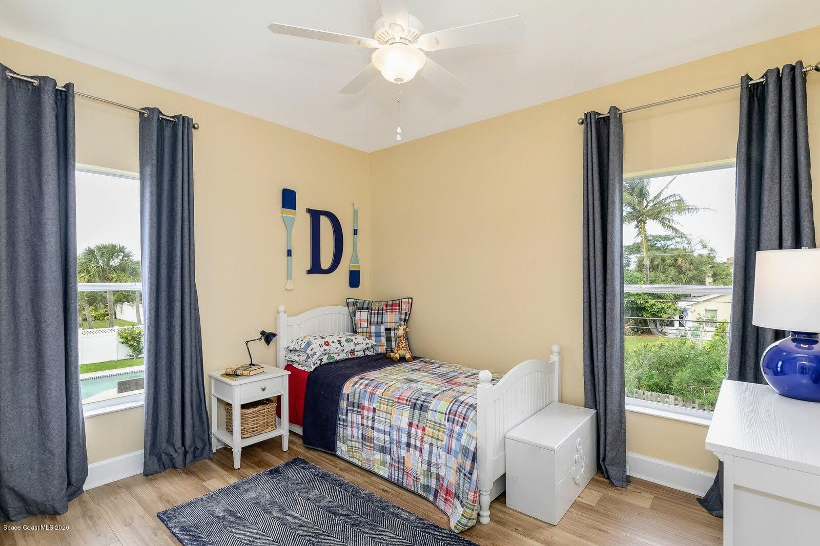 230 Richards Road Melbourne Beach, FL 32951 - Photo 30 of 42 a bedroom with a bed and a window