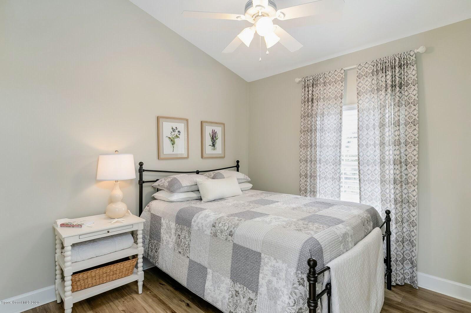 230 Richards Road Melbourne Beach, FL 32951 - Photo 31 of 42 a bedroom with a bed and a chandelier