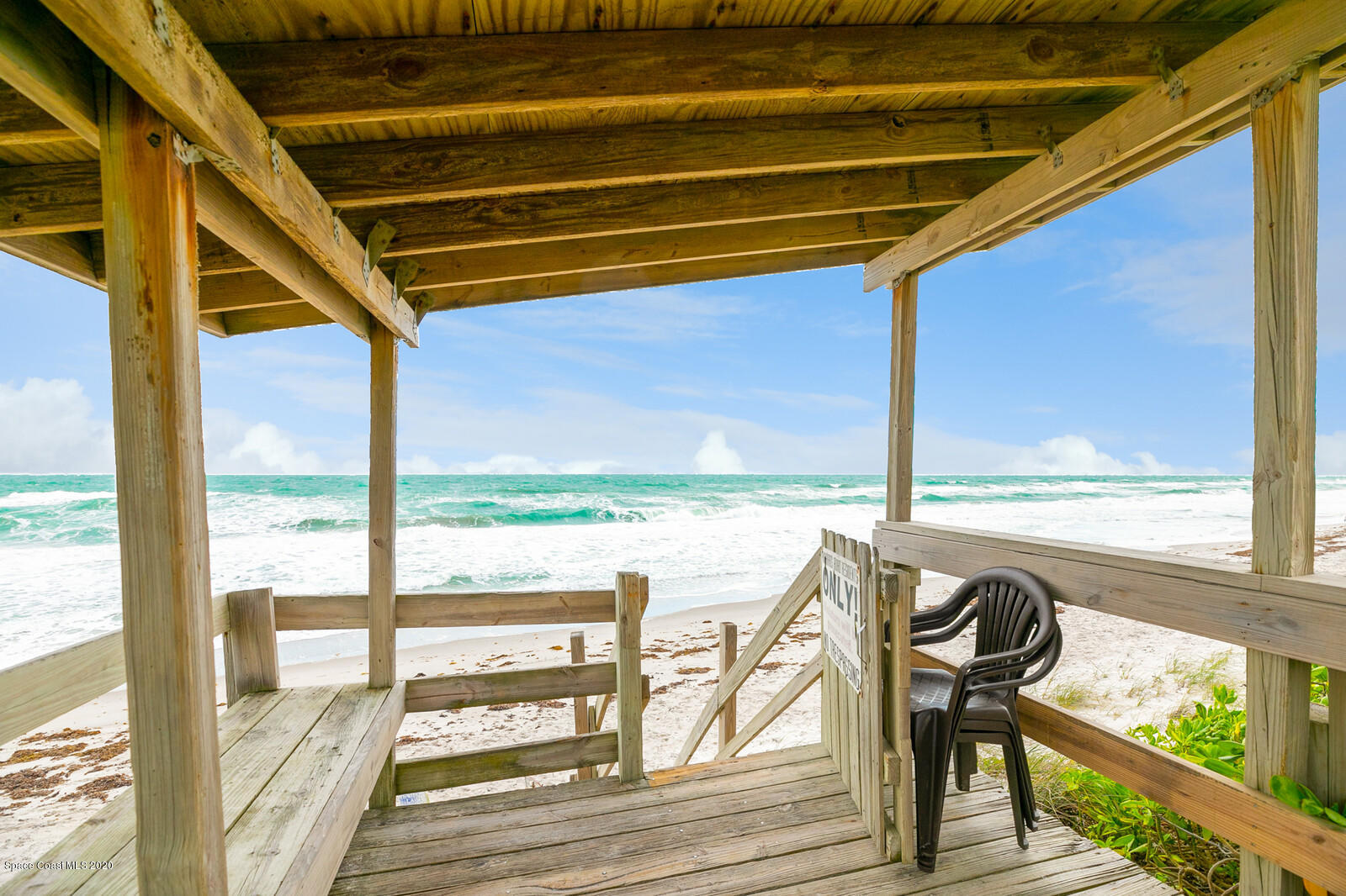 230 Richards Road Melbourne Beach, FL 32951 - Photo 38 of 42 a view of a balcony with chairs and wooden floor