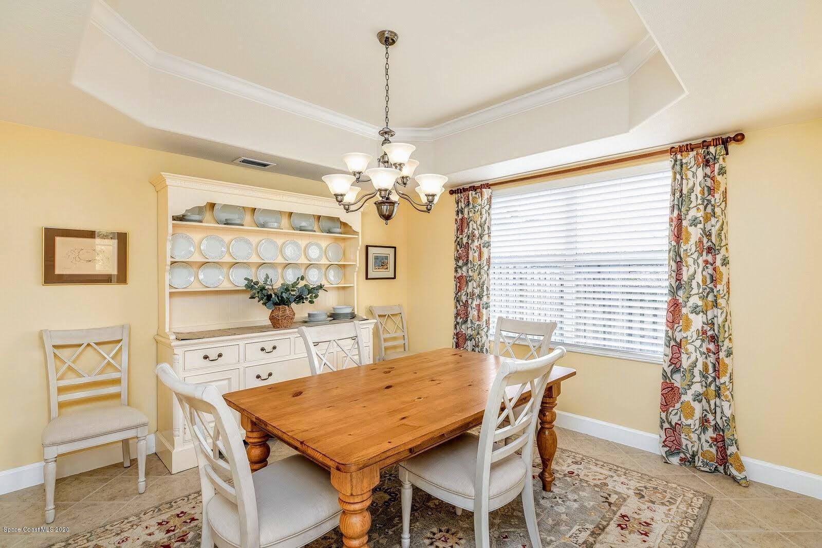 230 Richards Road Melbourne Beach, FL 32951 - Photo 9 of 42 a view of a dining room with furniture and chandelier