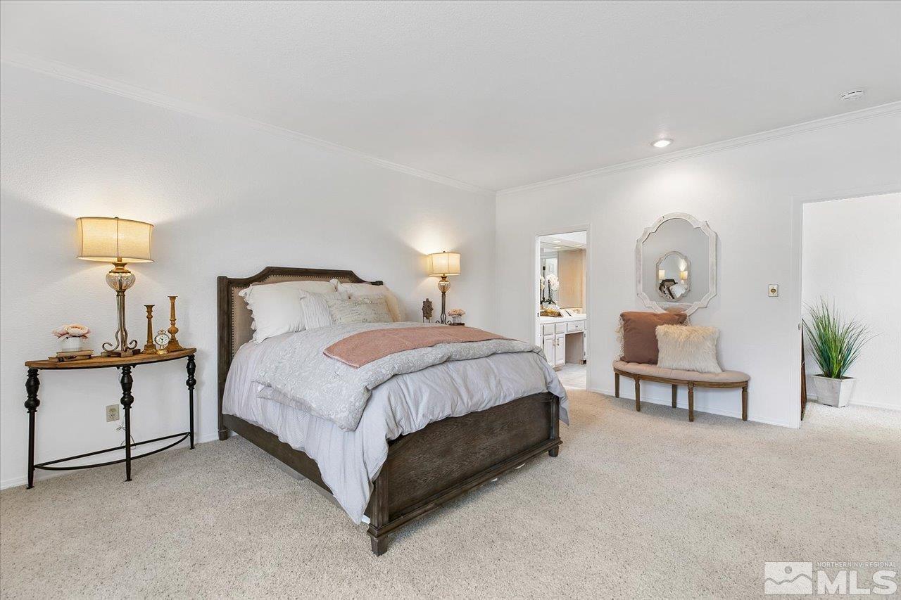4035 Caughlin Creek Road Reno, NV 89519 - Photo 19 of 40 a spacious bedroom with a bed and window
