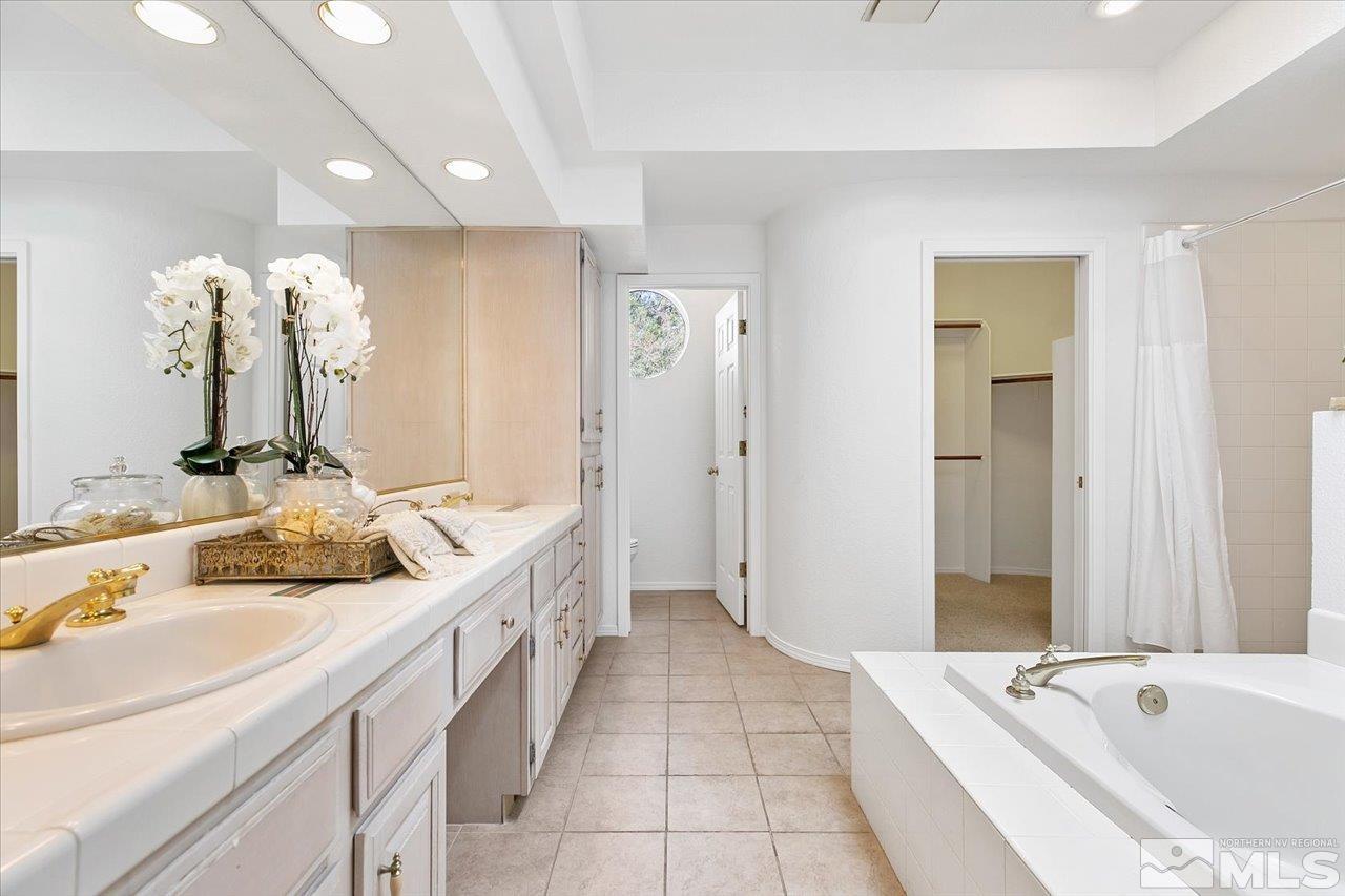 4035 Caughlin Creek Road Reno, NV 89519 - Photo 20 of 40 a spacious bathroom with a tub sink and mirror