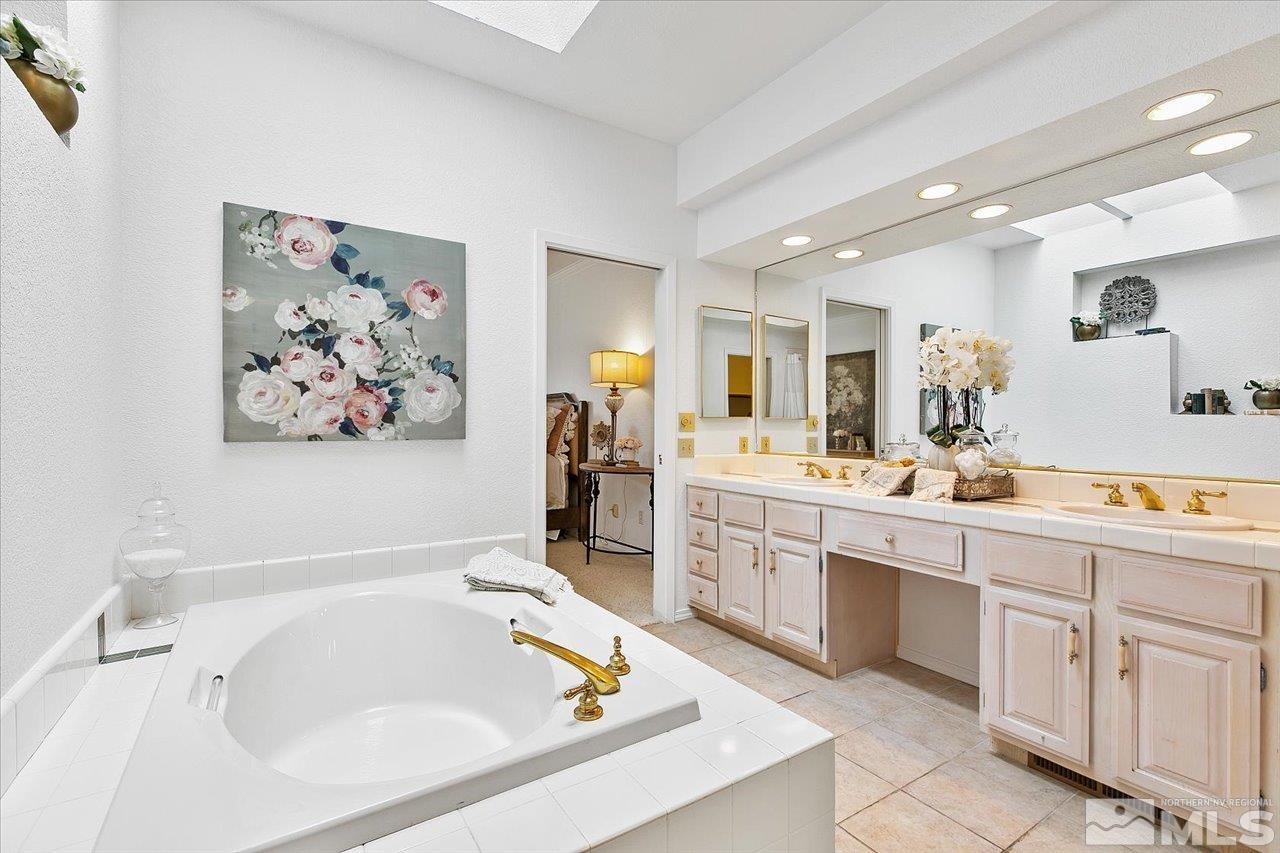4035 Caughlin Creek Road Reno, NV 89519 - Photo 21 of 40 a bathroom with a tub sink and mirror