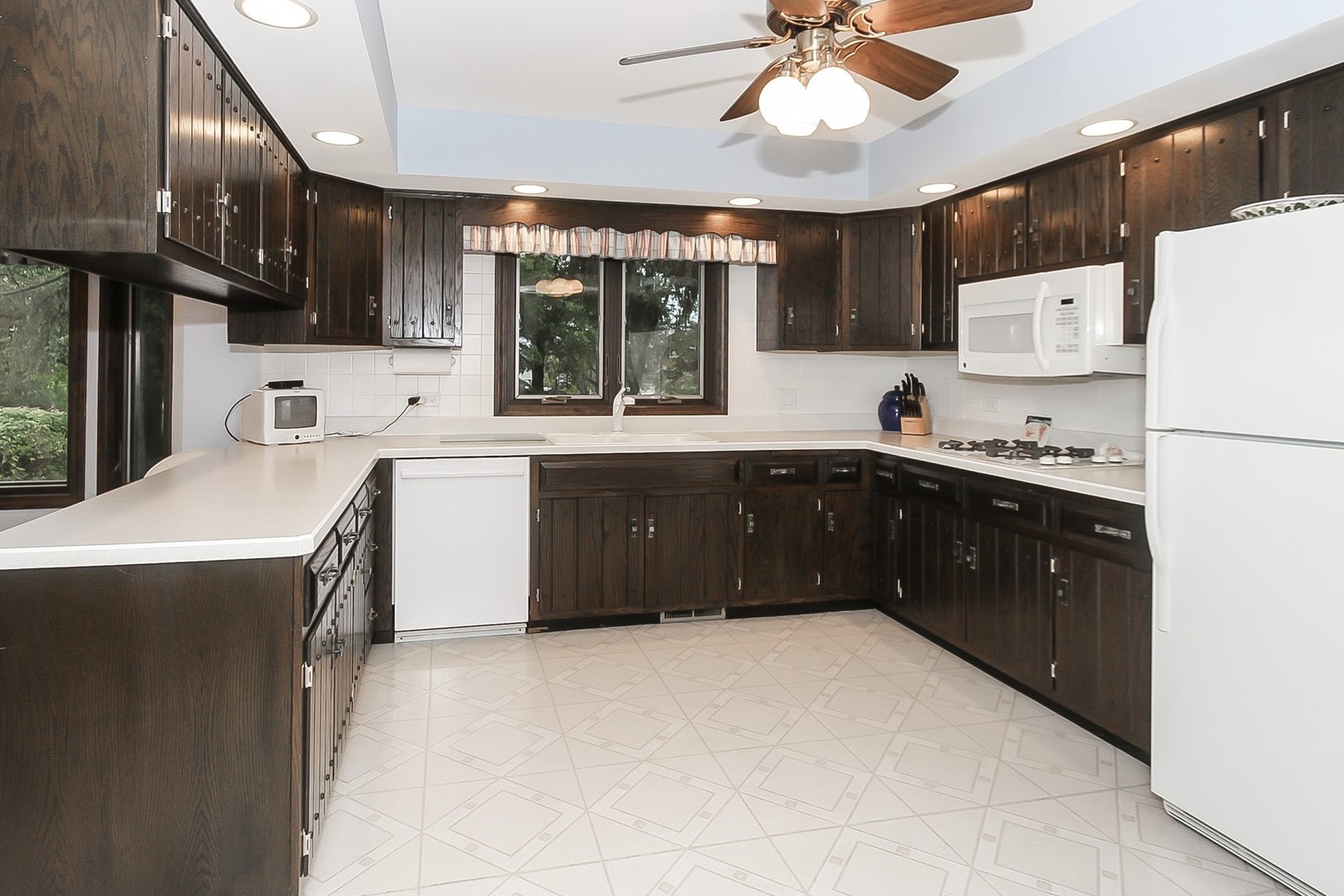 150 Shady Lane Bartlett, IL 60103 - Photo 8 of 34 a kitchen with a sink a stove and cabinets