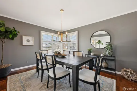 a view of a dining room with furniture and chandelier