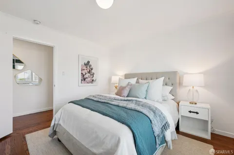 a bedroom with a bed and a couch