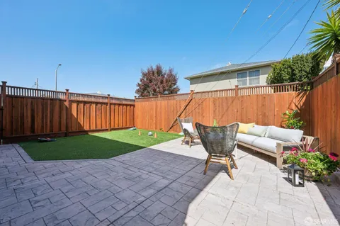 a view of a backyard with a table and chairs