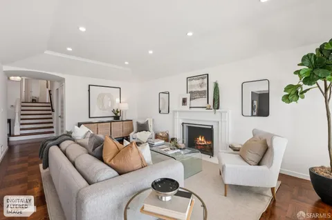 a living room with furniture fireplace and a couch