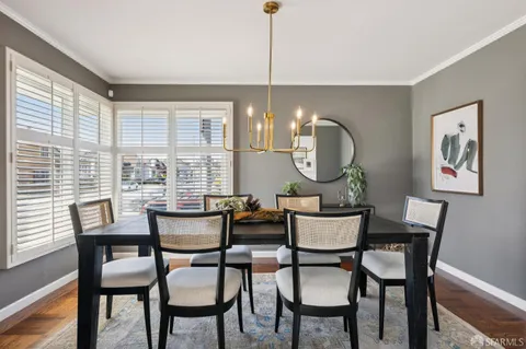 a dining room with furniture and window